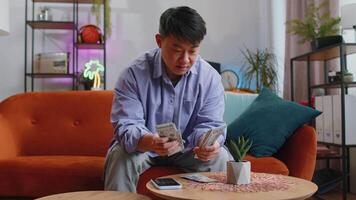 Rich happy man counting money cash and use calculator, calculate domestic income earnings at home video