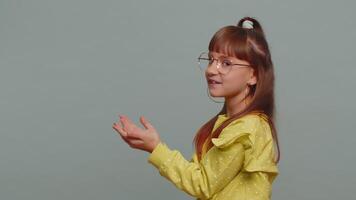 Girl child pointing empty place advertising area for commercial text, copy space for goods promotion video