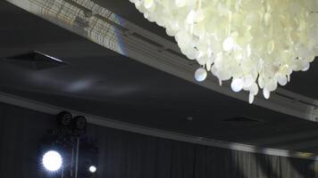 Elegant shell chandelier with event lighting video