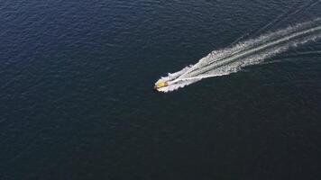 A yellow speedboat sails at high speed on the surface of the sea. video