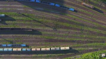 Empty platforms and railway tanks on an industrial railway siding. Drone view video