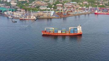 A cargo container ship slowly sailing in the dark waters. Drone view video