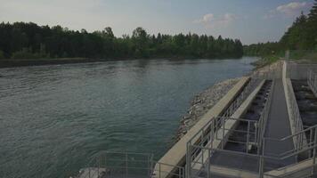Lech, Bavaria, Germany. Fish ladder for migration and spawning at river. Concrete fish ladder at a dam so can continue upstream. Pass for wild fish. River fishes stairs. video