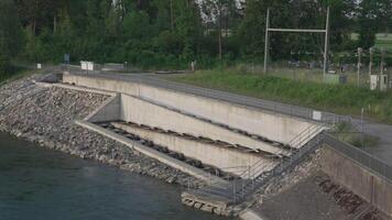 Lech, Bavaria, Germany. Fish ladder for migration and spawning at river. Concrete fish ladder at a dam so can continue upstream. Pass for wild fish. River fishes stairs. video