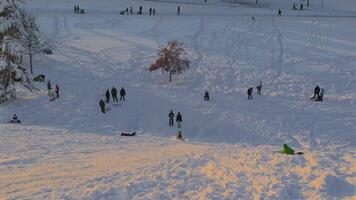 Munich, Germany, Riemer Park in Messestadt. Toboggan hill and observation deck hill in Riem park. Happy people skiing on snowy mountain in a park in munchen in sunny winter weather. video