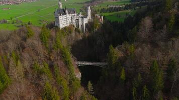 Aerial view Neuschwanstein Castle and bridge Marienbrucke across Pollat gorge in Ammergau Alps. View of famous Neuschwanstein Castle, Fussen, Bavaria, Germany and Marys bridge over cliff video