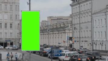 Green screen advertising billboard on the highway exit of the subway station with a city background crowded with workers passing by, suitable for promoting products video