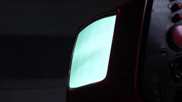 Old analog television set displaying static noise in dark room video