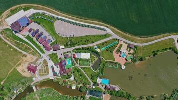 Modern resting zone. Panoramic view of a recreation complex surrounded by beautiful nature in summer. Aerial view. Camera moving around. video