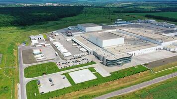 Contemporary industrial complex. Huge territory of production plant on nature background. View from the air. Motion camera top down. video