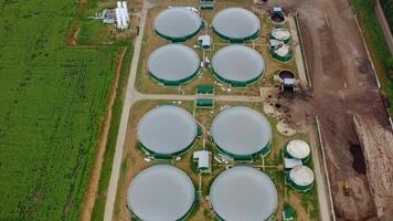 Modern biogas plant on field. Flying over the storage tanks for biomass production. Environmentally friendly biogas plant. Top view. video