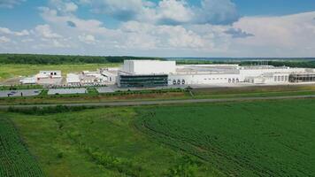 Modern industrial plant in green fields. Large territory of innovative factory among green nature in summer. Aerial view. Camera moves to the right. video