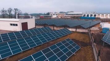 Solar power station on field. Solar panels for power production. Solar farm. Renewable green energy. Alternative energy sources. Drone flight. Motion camera back. video