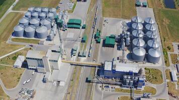 Large granary on field. Modern territory of a new built-in industrial grain elevators. Silo for storing agricultural products. Aerial view. video