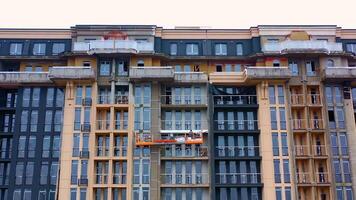 Building of a modern block of flats. Construction of a tower building in the city. Front view of a high-rise architecture. video