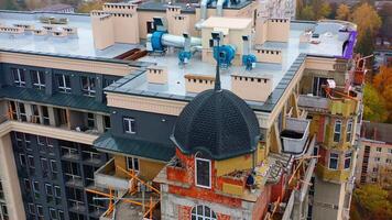 Construction of modern tower house. Workers build the on the top of multi-storey building. New high-rise architecture under construction in the city. video