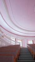 Empty auditorium at university. Large classroom with rows of wooden desks without students. Steps among tables in the large lecture hall. Pandemic. Vertical video