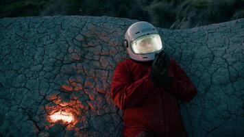 Astronaut With Helmet Lying On A Rock At Night On A Lifeless Planet video