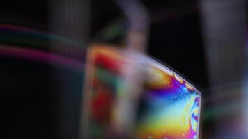 Bright rainbow reflection of liquid in macro, white colors, surrealistic background, fantastic smooth movement, water surface, spectrum texture video