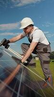 Engineer installing solar panels on a sunny day using a drill video