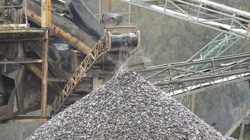 Pebbles conveyor in a quarry putting down stones over a pebbles mountain video