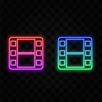 Glowing neon line Play icon isolated on black background. Film strip with game board. Colorful outline concept. vector