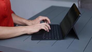Close up of a womans hands on keyboard of lap top video