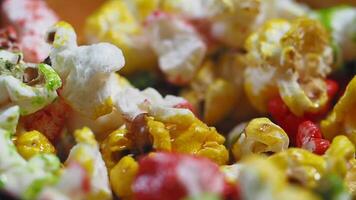 slow motion of colorful popcorn dropping in a bowl video