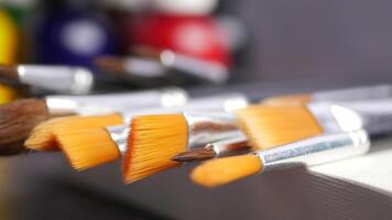 A Variety of Assorted Paintbrushes on Canvas Set Against Colorful Backgrounds video