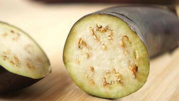 Freshly Sliced Eggplant Displayed on a Rustic Wooden Background video