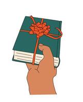 Hand holding a book with a red bow on it. The book is green and has a red bow tied around it. vector