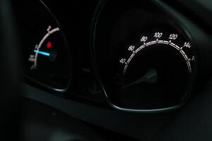 Close up shot of a speedometer in a car. At an engine speed of 1800 rpm photo