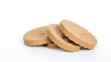 Three round beige pet treats on white background. photo