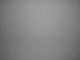 A gray background with a pattern of small squares photo
