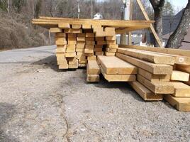 A pile of lumber on the side of a road. photo