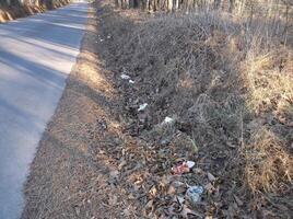 A road with trash on the side of it photo
