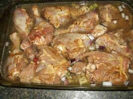 A pan filled with chicken and onions photo