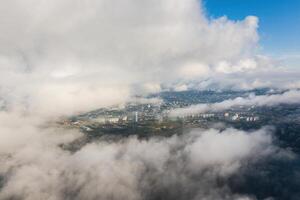 An epic drone view of Vladivostok in cloudy weather with low cinematic fog photo