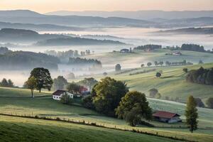 foggy countryside with houses and trees in the foreground photo