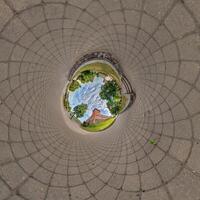 blue sphere inside overlookingtown, urban development, historic buildings surrounded by a frame of paving slabs. Transformation of spherical 360 panorama in abstract aerial view. photo