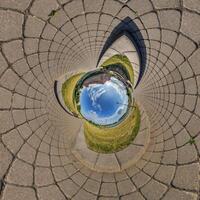blue sphere inside overlooking old town, urban development, historic buildings surrounded by a frame of paving slabs. Transformation of spherical 360 panorama in abstractview. photo