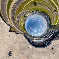 blue sphere inside overlooking town, urban development, historic buildings surrounded by a frame of paving slabs. Transformation of spherical 360 panorama in abstract aerial view. photo
