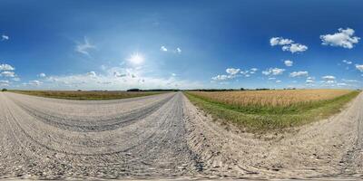hdri 360 panorama of blue sky with awesome clouds on road among fields in equirectangular full seamless spherical projection, for VR AR content or skydome replacement photo