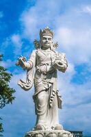Sculpture of a Buddhist god on the marble mountains in Da Nang. photo