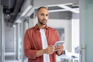 A focused individual in a contemporary office setting. The image depicts modern technology, effective communication, and professionalism in a work or business-related atmosphere. photo