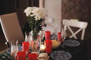 An Elegant Dinner Table Setting Featuring Beautiful Flowers and Festive Decorative Elements photo