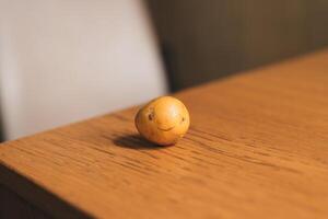 A whimsical potato character on a rustic table embodies joy, inviting smiles and laughter photo