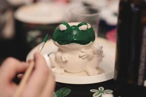 Engaging and Creative Frog Art Project Using Vibrant Green Paint for Artistic Expression photo