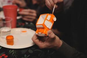 Engaging in a delightful and creative orange craft project within a vibrant social setting photo
