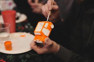 Engaging in the Exciting Activity of Creating Fun Art Using Orange Paint and Various Craft Supplies photo